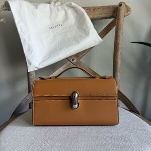 Savette symmetry pochette in saddle leather